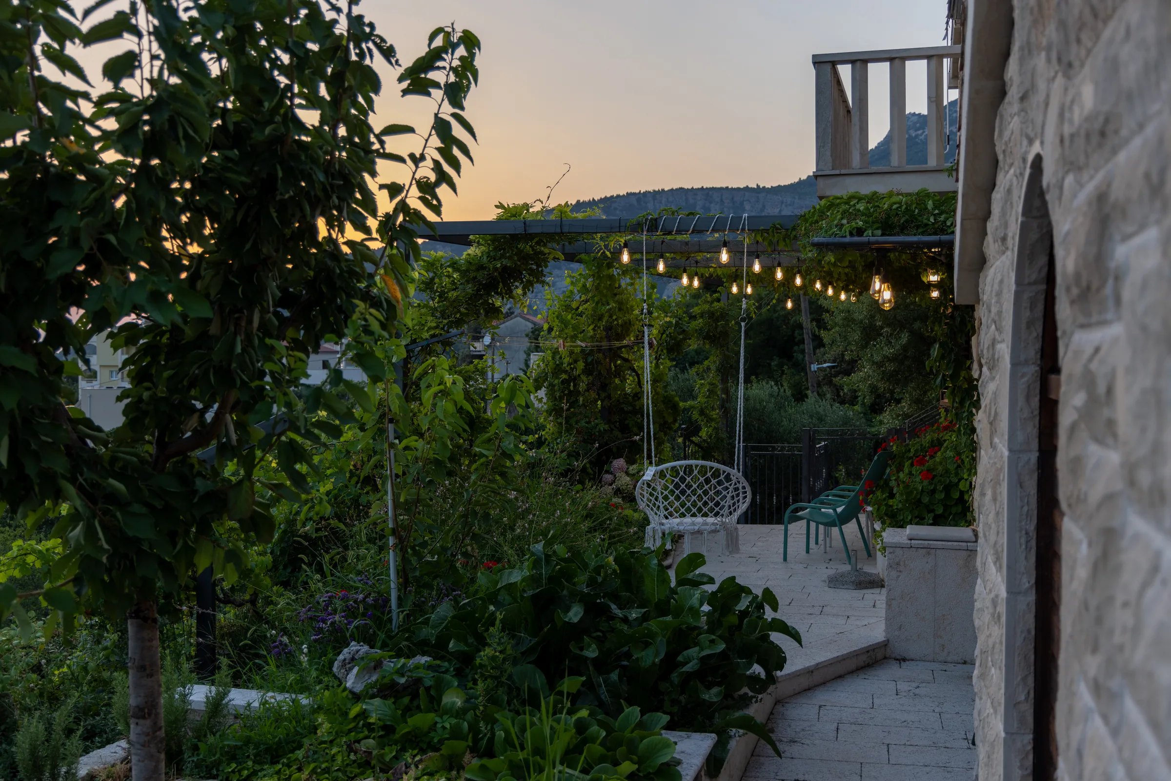 Garden terrace and evening lights beside Villa Dalmatia