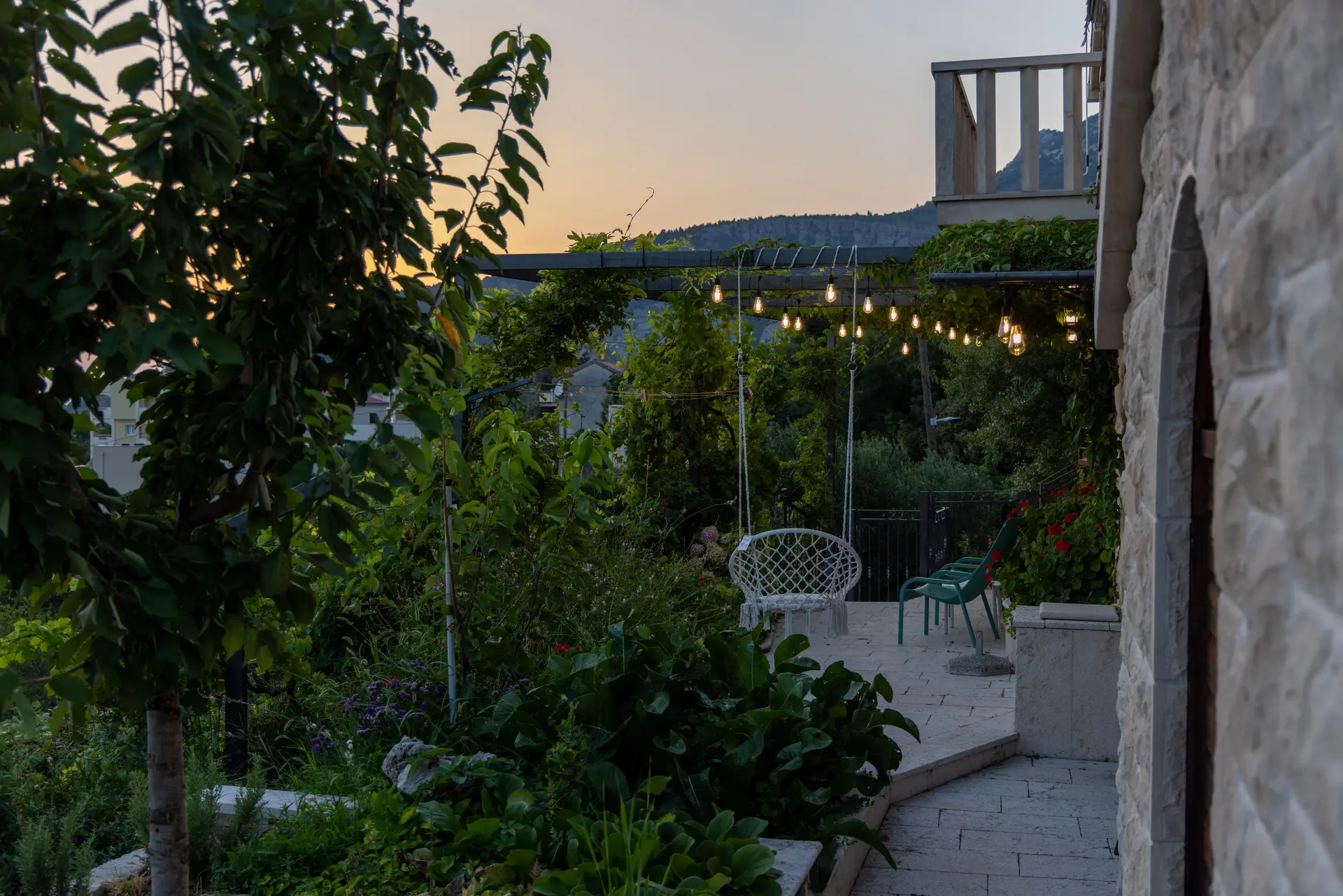 Garden terrace and evening lights beside Villa Keti