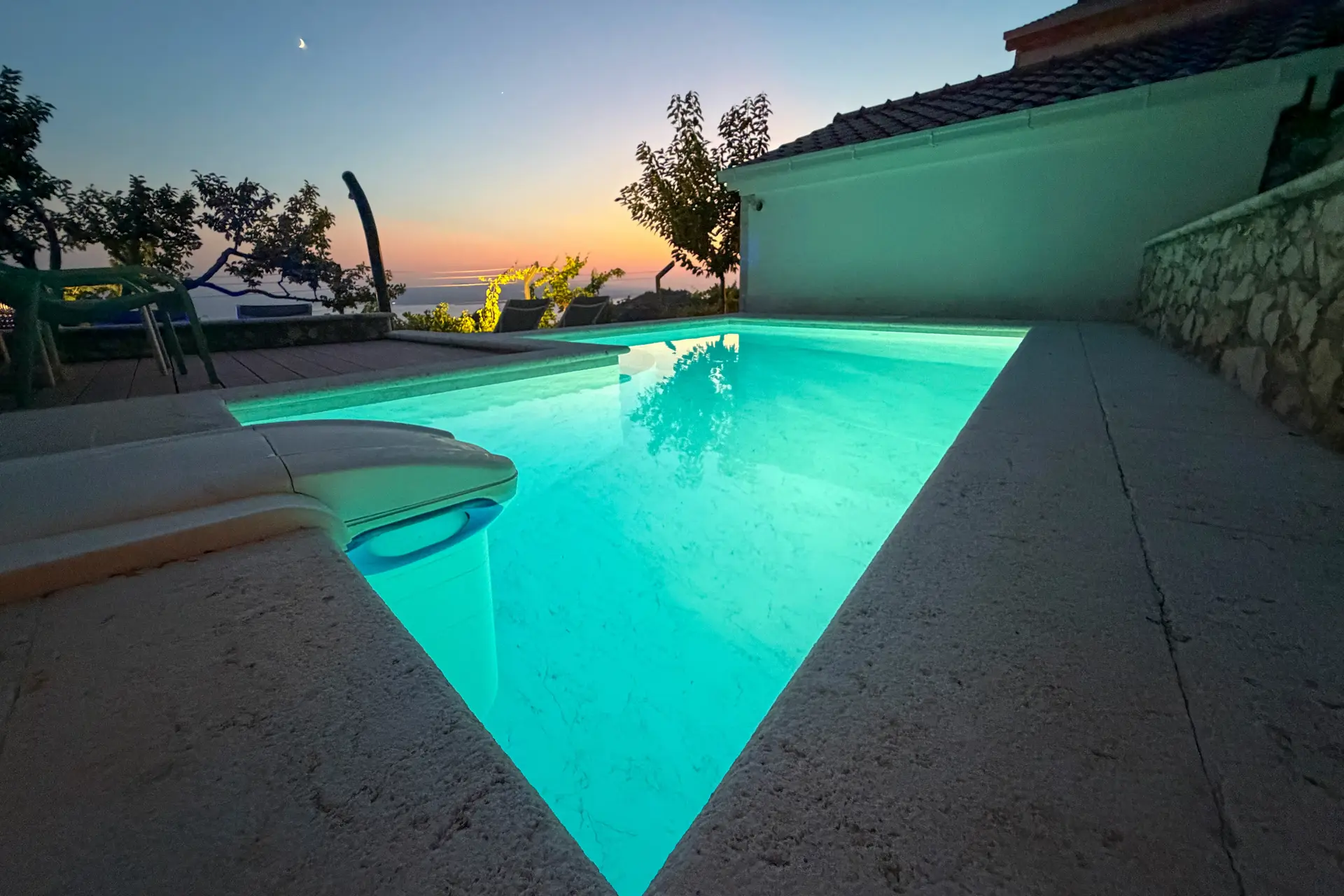 Private pool and stone terrace at Villa Keti at dusk