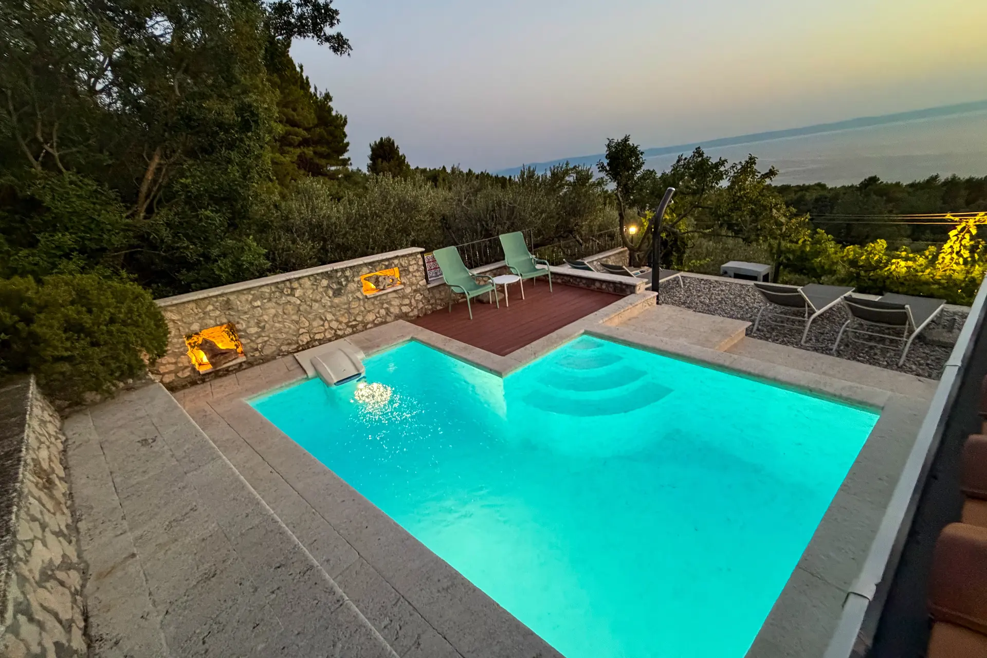 Illuminated private pool at Villa Keti after sunset